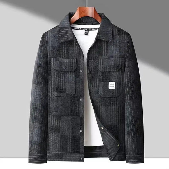 A checkered Montaro Classic Layer Jacket with sleeve pockets, a collar, and subtle stitching, displayed on a wooden hanger.